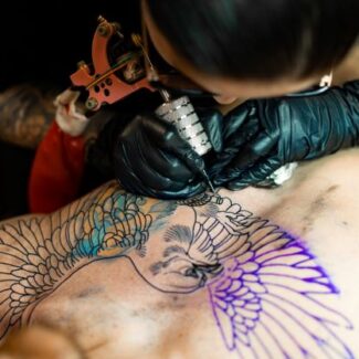 girl-tattooing-wings-chest-area2